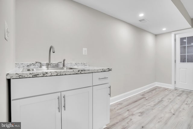 washroom featuring sink and light hardwood / wood-style flooring