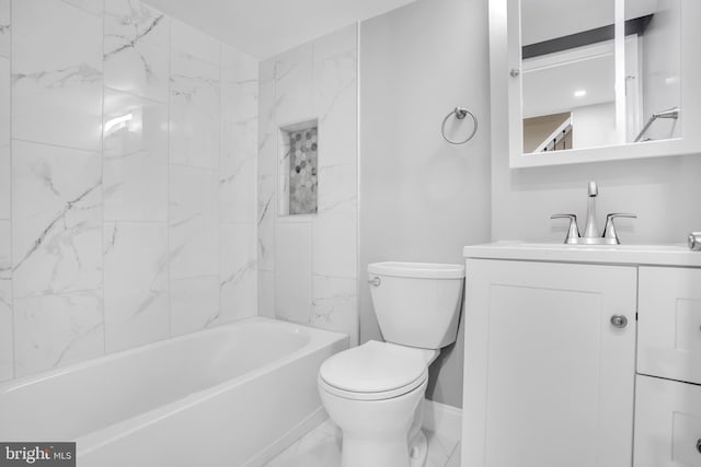 full bathroom featuring vanity, tiled shower / bath combo, and toilet