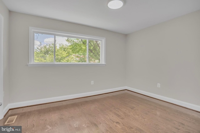 spare room featuring light wood-type flooring