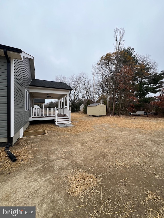 view of yard with covered porch and a shed