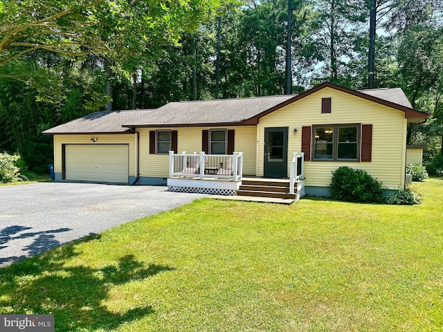 single story home featuring a front lawn, a porch, and a garage