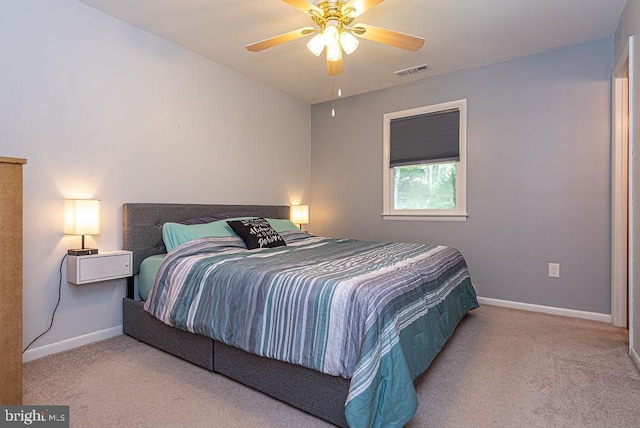 bedroom with ceiling fan and light colored carpet