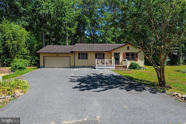 single story home with a front yard and a garage