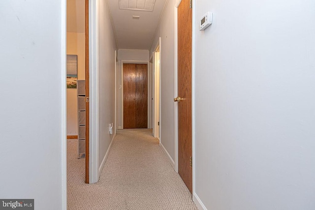 hallway featuring light colored carpet