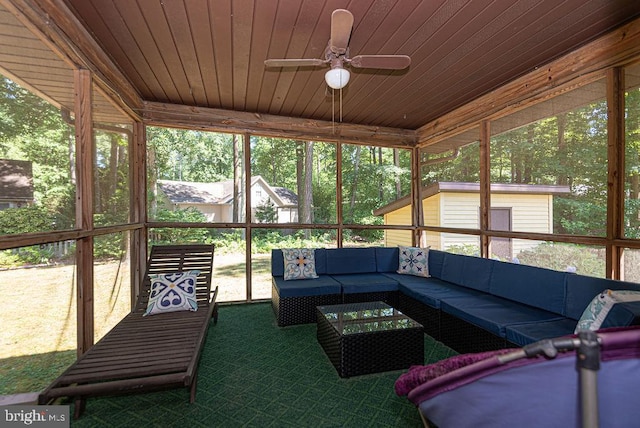 sunroom with ceiling fan, plenty of natural light, and wooden ceiling