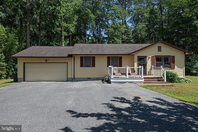 ranch-style house with covered porch and a garage