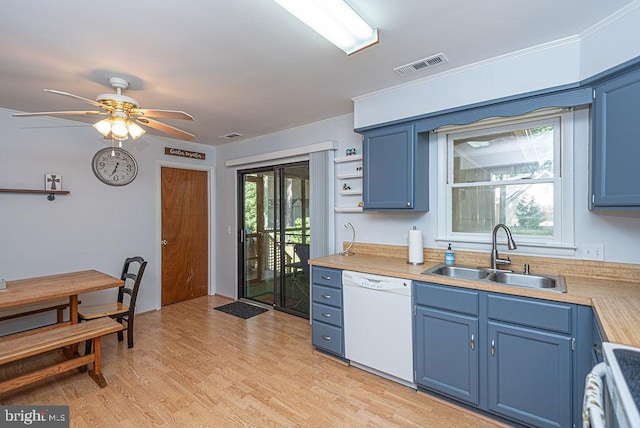 kitchen featuring blue cabinetry, dishwasher, light wood-type flooring, and sink