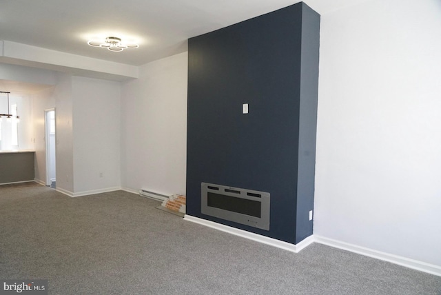 spare room with carpet flooring and a baseboard radiator