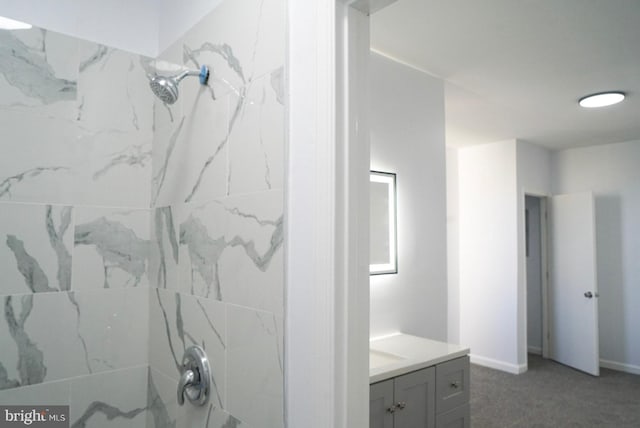 bathroom featuring vanity and a tile shower