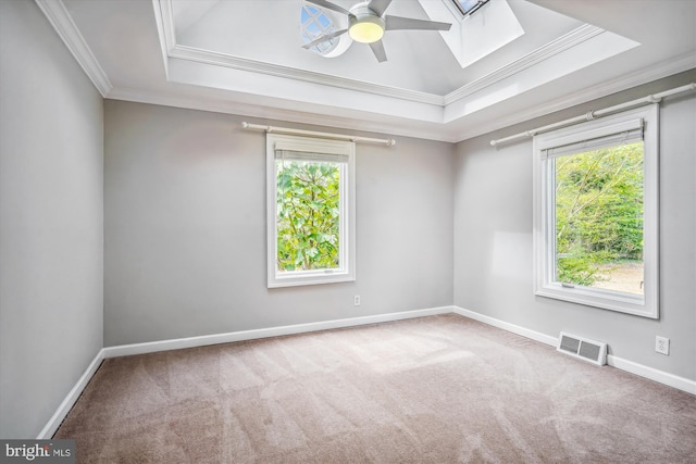 unfurnished room featuring a tray ceiling, ceiling fan, carpet, and ornamental molding