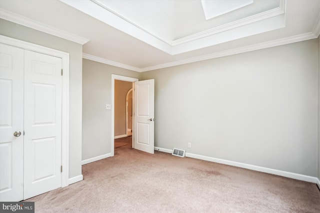 unfurnished bedroom with light carpet, a closet, and ornamental molding