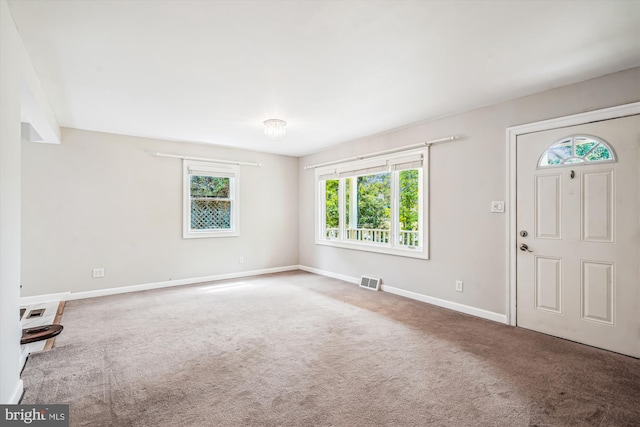 foyer entrance with carpet