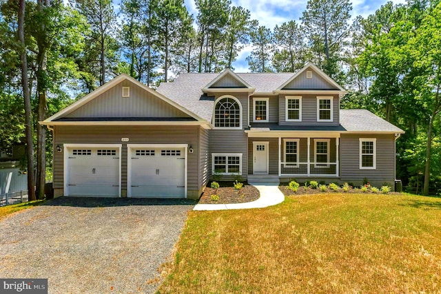 craftsman inspired home with covered porch, a garage, and a front lawn