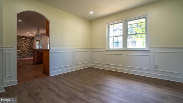 spare room with dark hardwood / wood-style flooring