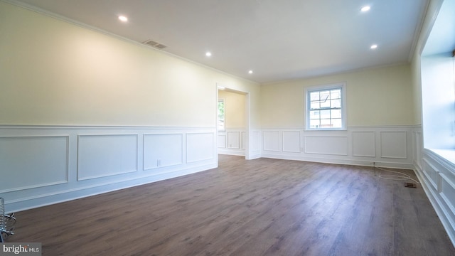 spare room with dark hardwood / wood-style floors and ornamental molding