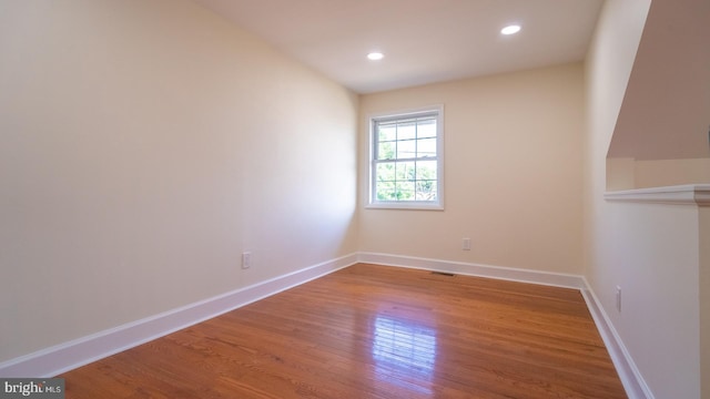 spare room with wood-type flooring