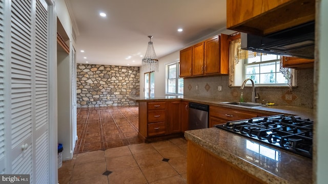 kitchen featuring stainless steel dishwasher, kitchen peninsula, sink, and a wealth of natural light