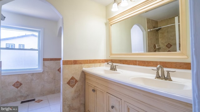 bathroom with vanity, tile patterned floors, and tile walls