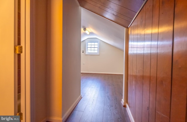 hall with wood-type flooring and lofted ceiling