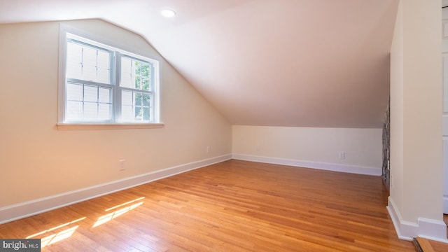 bonus room featuring light hardwood / wood-style flooring and lofted ceiling