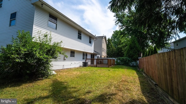 view of yard with central AC unit and a deck