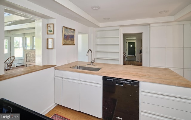 kitchen featuring light hardwood / wood-style floors, sink, white cabinetry, and black dishwasher