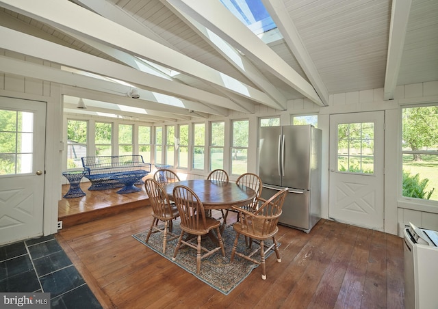 sunroom / solarium featuring vaulted ceiling with beams and a healthy amount of sunlight