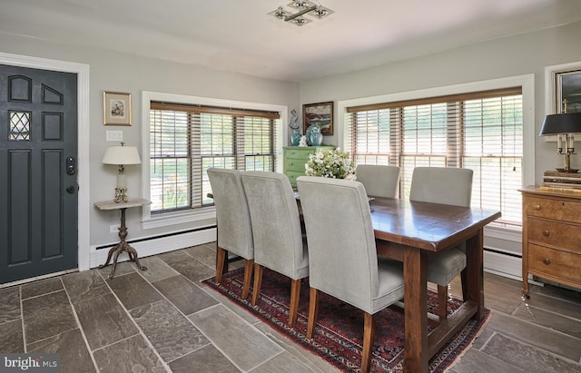 dining area with plenty of natural light and baseboard heating