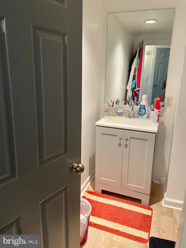 bathroom featuring hardwood / wood-style flooring and vanity