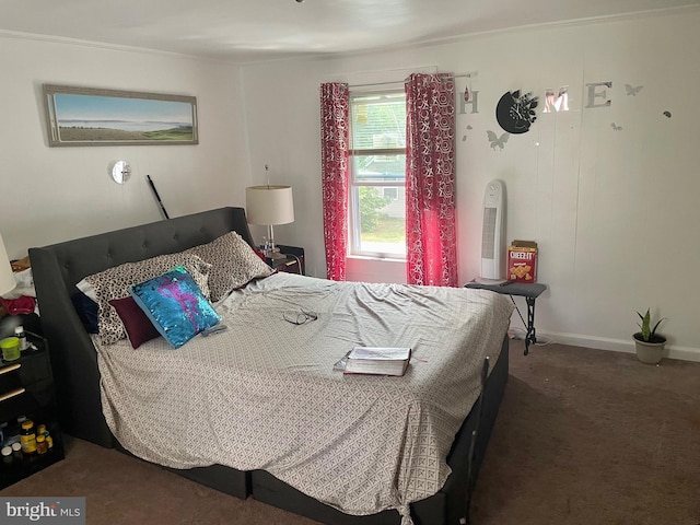 bedroom with dark carpet and ornamental molding