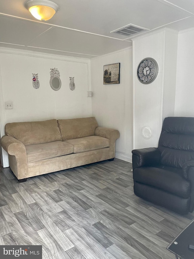 living room with crown molding and hardwood / wood-style floors