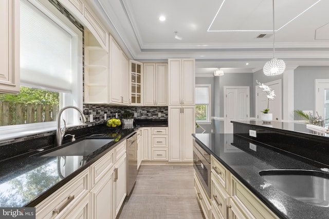 kitchen featuring dishwasher, dark stone counters, sink, built in microwave, and decorative light fixtures