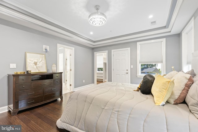 bedroom featuring a raised ceiling, crown molding, and dark wood-type flooring