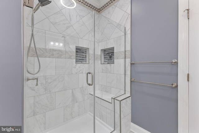 bathroom featuring a shower with shower door