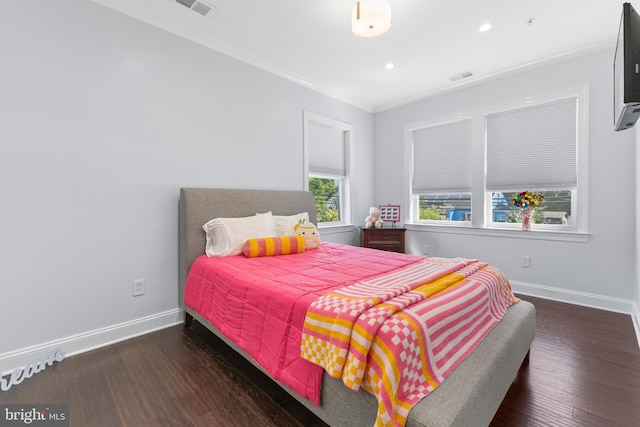 bedroom featuring dark hardwood / wood-style flooring and crown molding