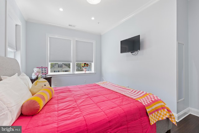 bedroom featuring wood-type flooring and crown molding