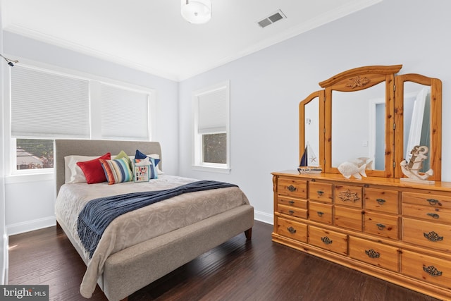 bedroom featuring crown molding and dark wood-type flooring