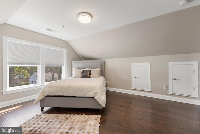 bedroom featuring dark hardwood / wood-style floors and vaulted ceiling