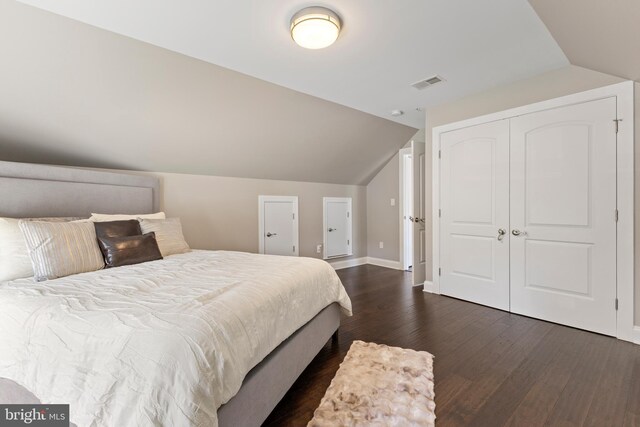 bedroom with dark hardwood / wood-style flooring and vaulted ceiling