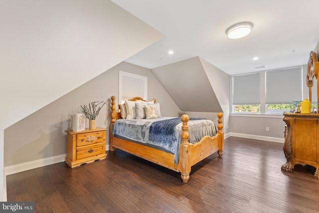 bedroom with dark hardwood / wood-style flooring and vaulted ceiling