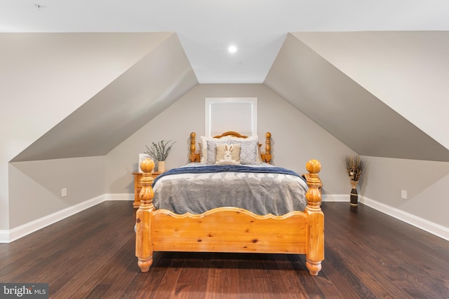 bedroom featuring hardwood / wood-style floors and lofted ceiling