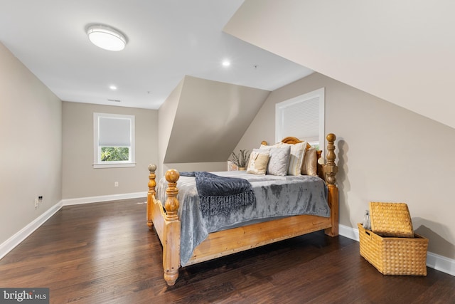 bedroom featuring dark wood-type flooring and vaulted ceiling