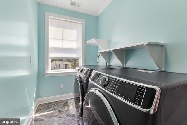 washroom featuring independent washer and dryer, plenty of natural light, and crown molding