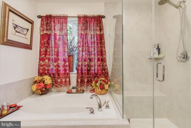 bathroom with shower with separate bathtub