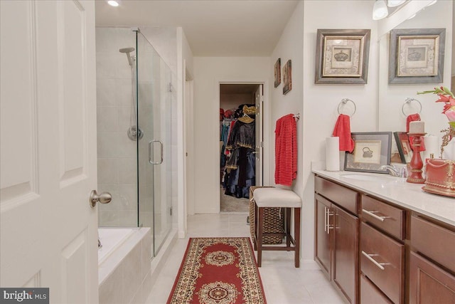 bathroom with tile patterned flooring, vanity, and separate shower and tub