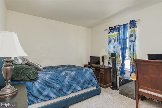 bedroom featuring light carpet