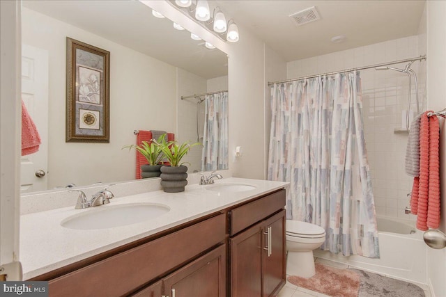 full bathroom with toilet, vanity, tile patterned floors, and shower / bath combo with shower curtain