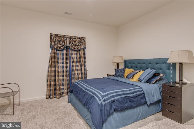 bedroom featuring light colored carpet