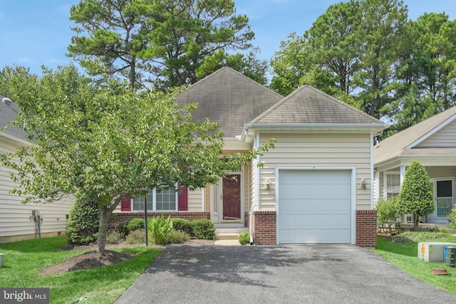 view of front facade with a garage, brick siding, driveway, and a shingled roof