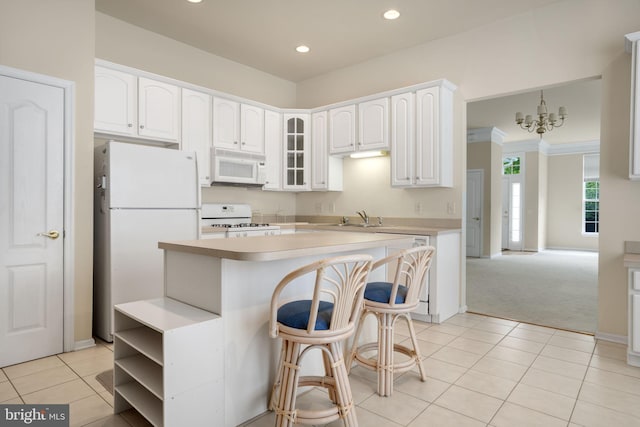 kitchen featuring light tile patterned floors, light countertops, glass insert cabinets, white cabinetry, and white appliances